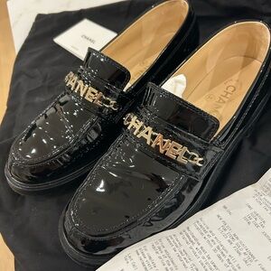 CHANEL Glossy Black Loafers with Gold Logo